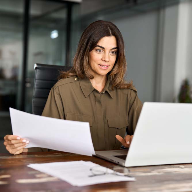 busy-business-woman-of-middle-age-working-on-laptop